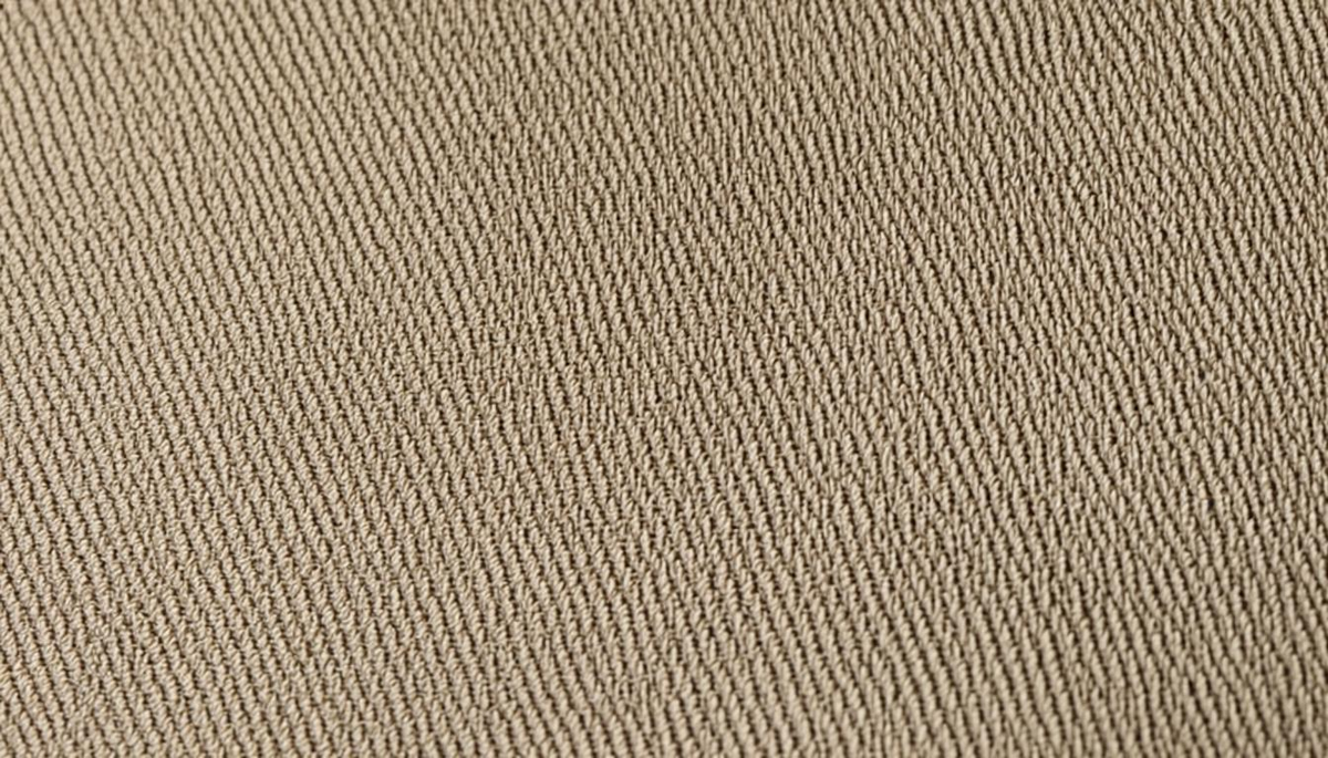 Close-up macro of twill weave cotton fabric showing diagonal rib pattern